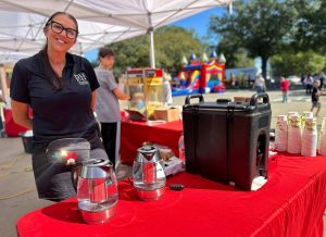 RH Events & Catering team member at an outdoor event beverage station