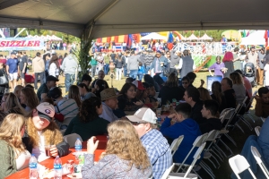 Large group of employees eating together at a company picnic