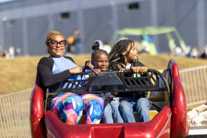 family enjoying a ride at company picnic