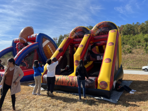 Kids enjoying inflatable games at company family fun day